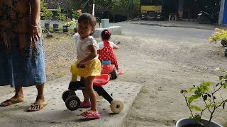 Playing tricycle with twin brothers